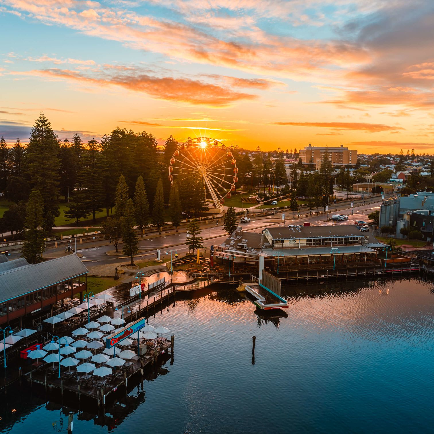 A Body Of Water With Buildings And Trees Around It
