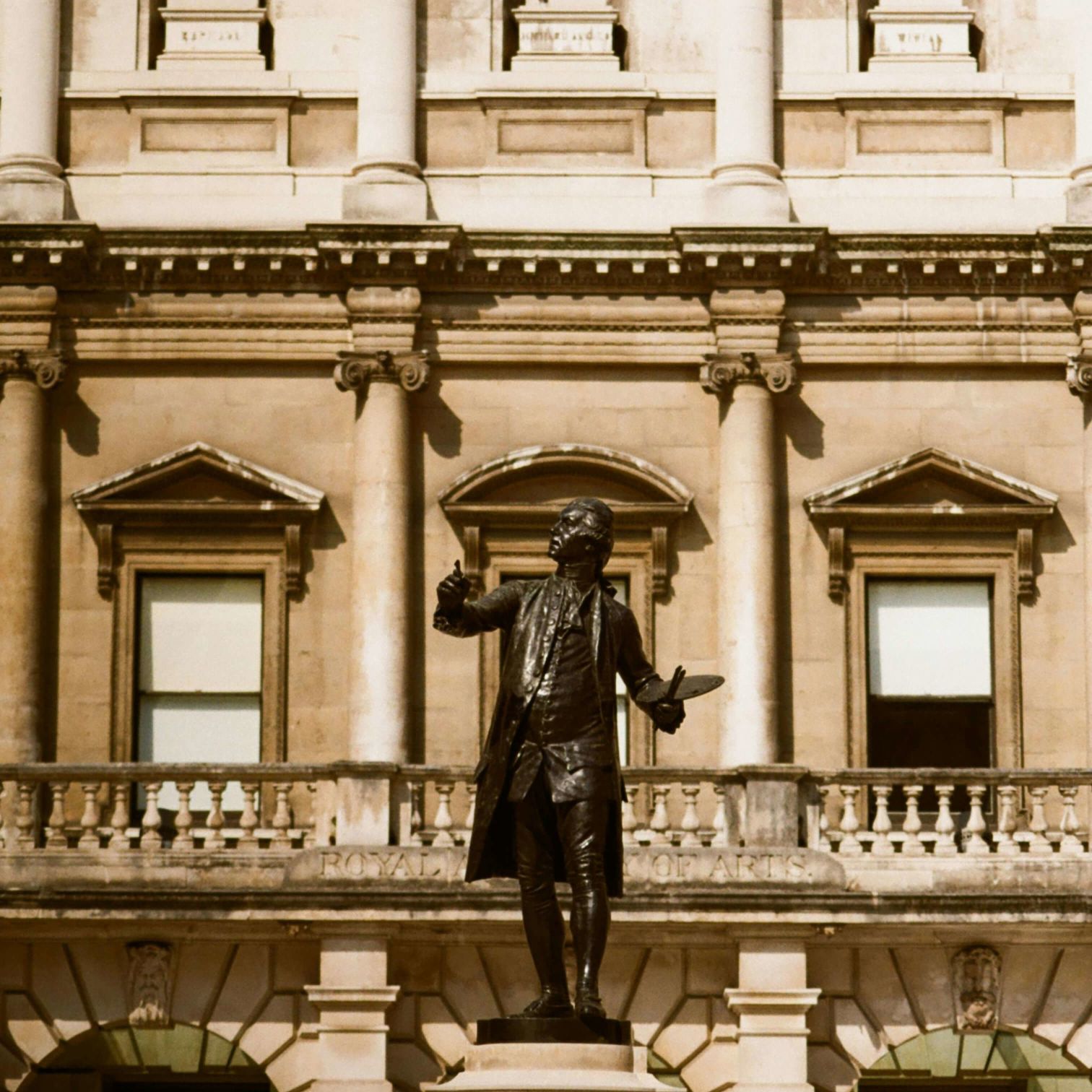 A Statue Of A Person In Front Of A Building