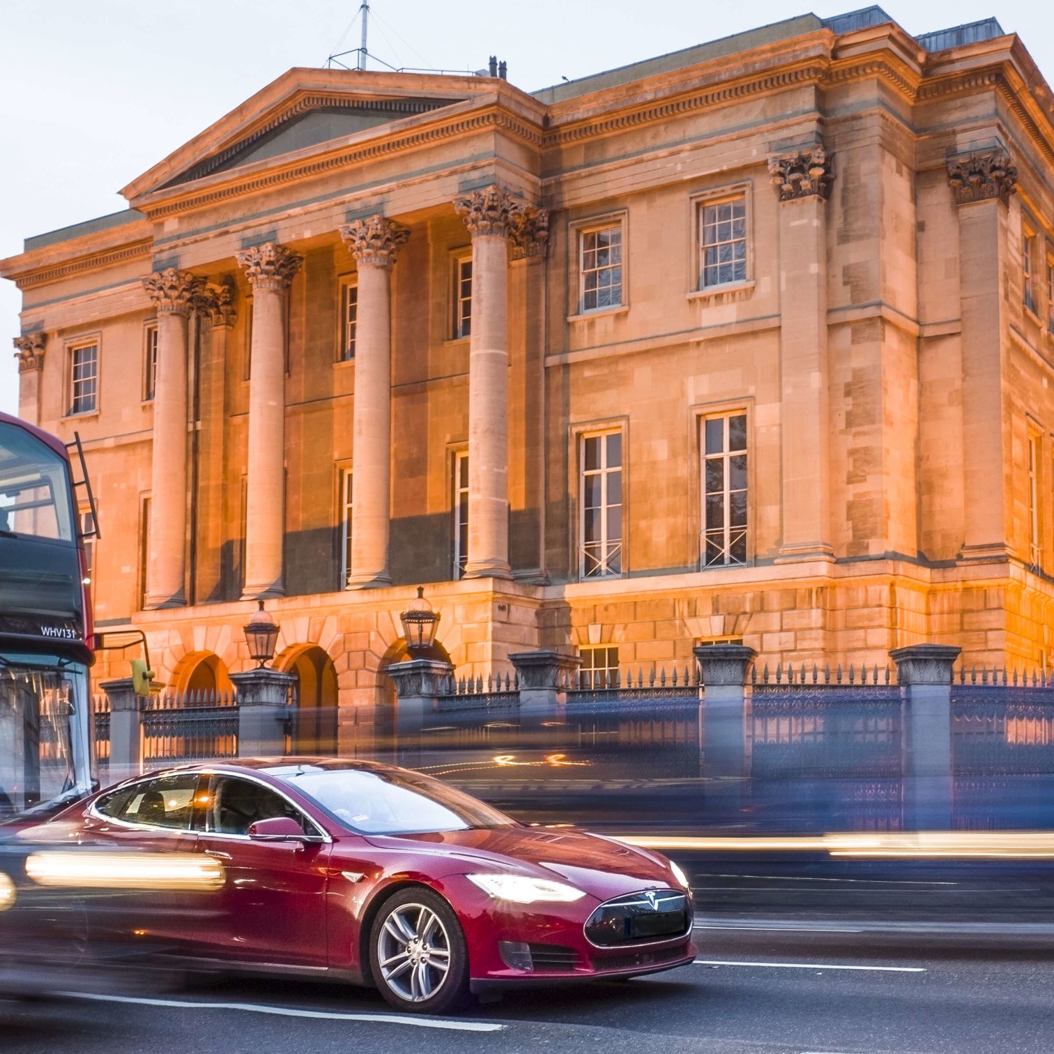 A Red Sports Car Parked In Front Of Apsley House With Columns