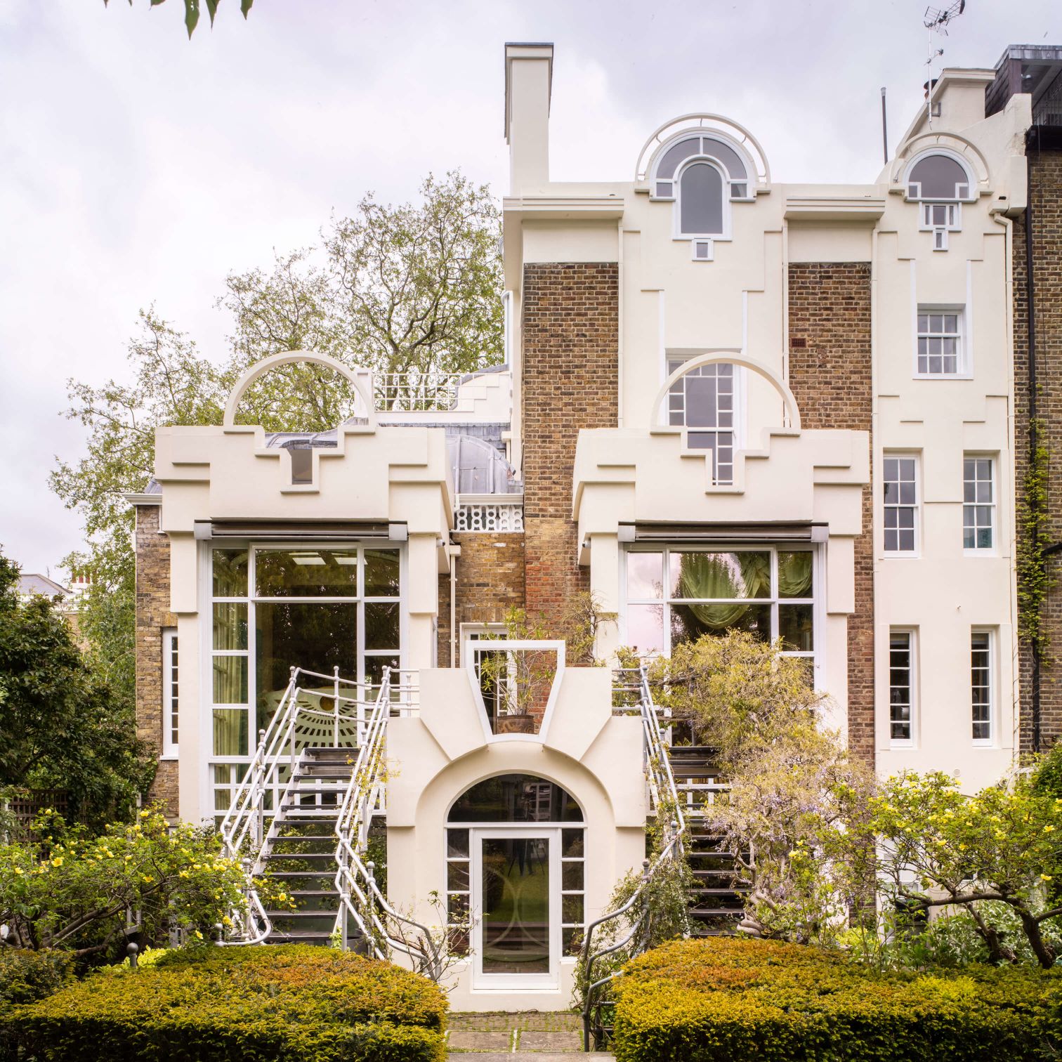 A Large White House With Stairs
