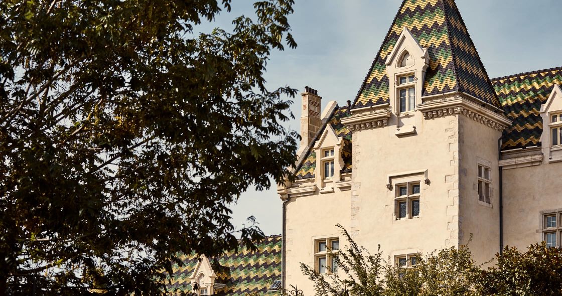 A Building With A Tree In Front Of It