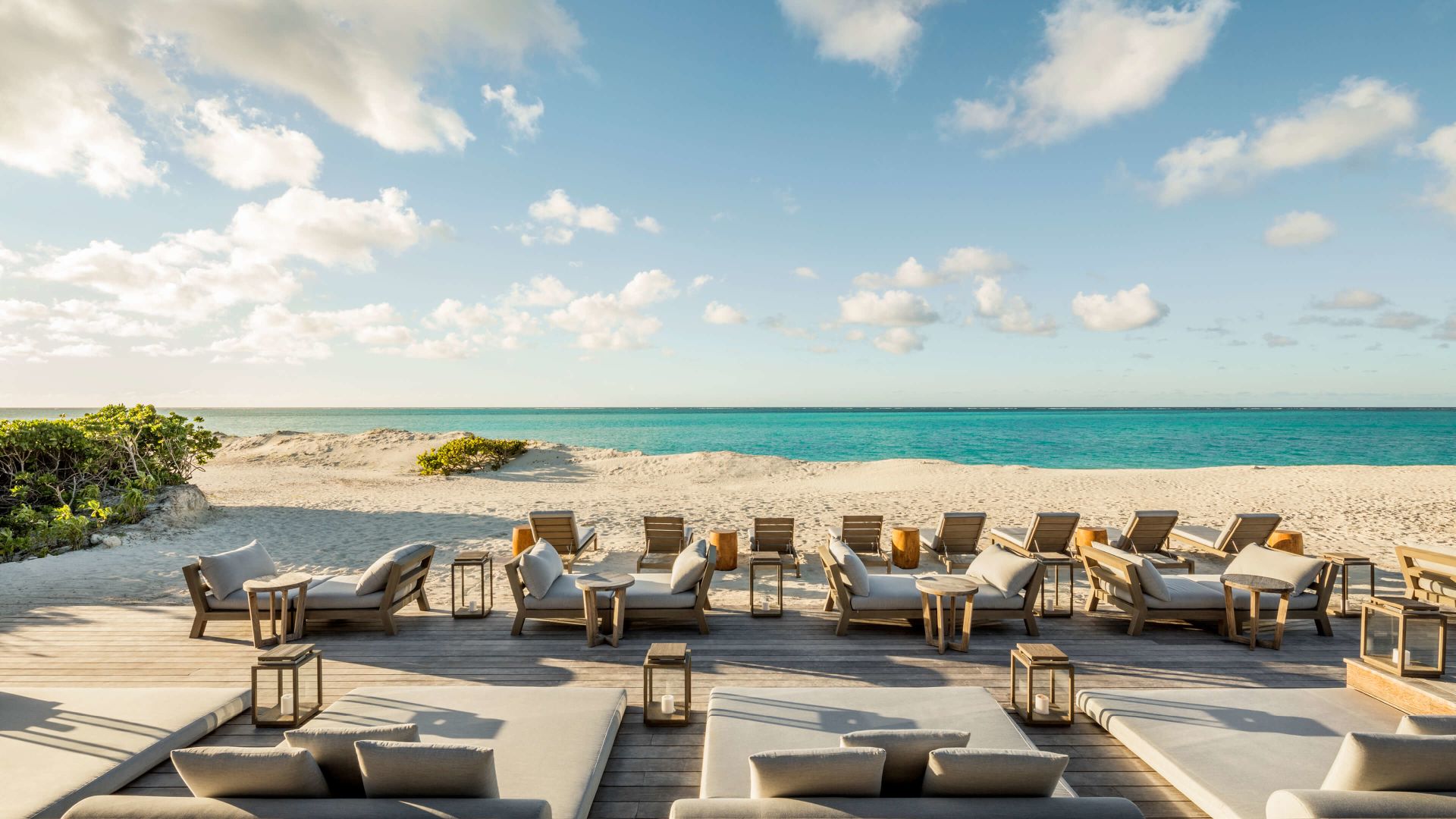 A Beach With Chairs And Tables