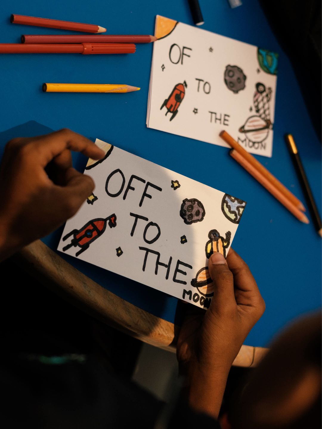 A Person Drawing On A White Board