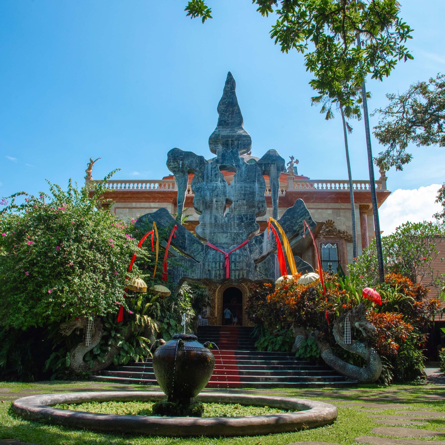 A Colorful Building With A Large Statue In Front Of It