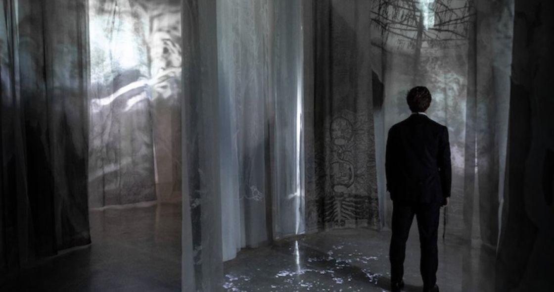 A Man Walking Through A Building