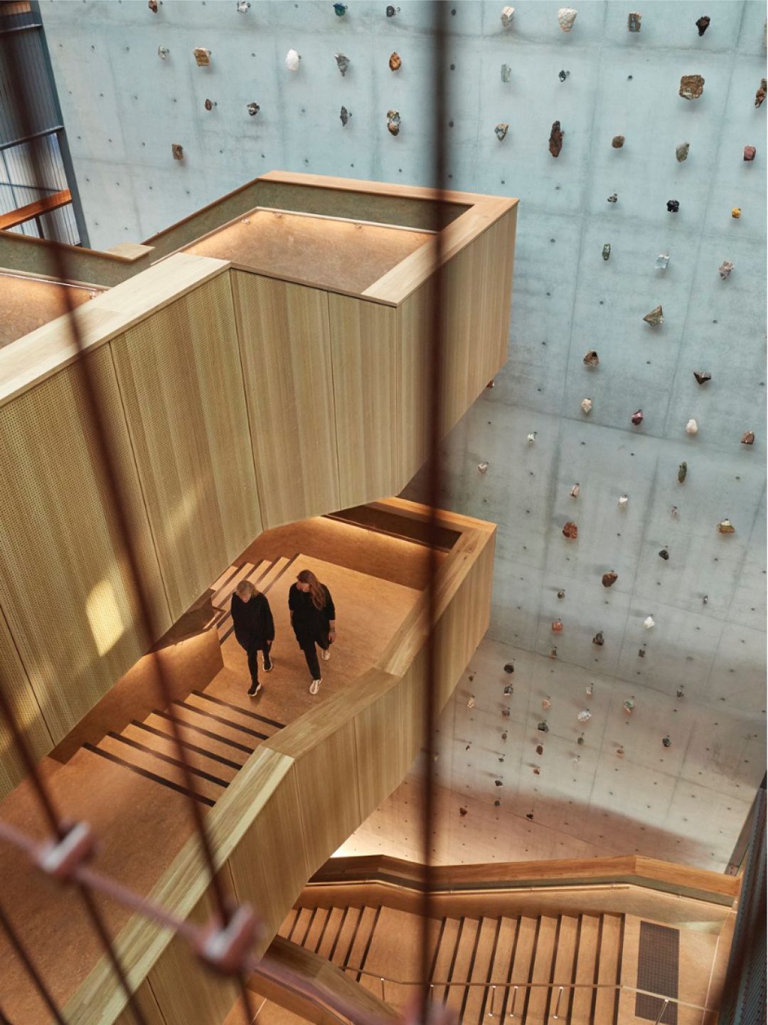 A Couple Of People Walking Up A Staircase