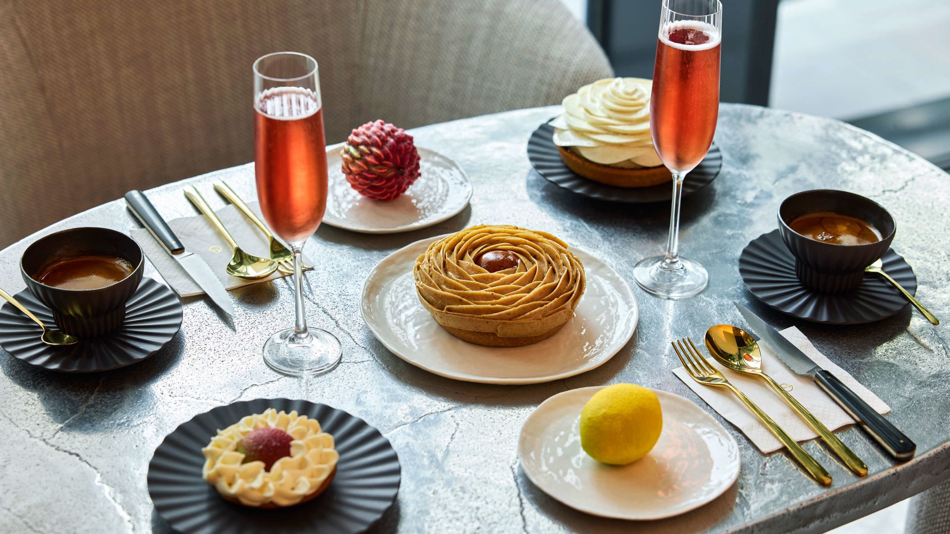 A Table With Plates Of Food And Drinks On It