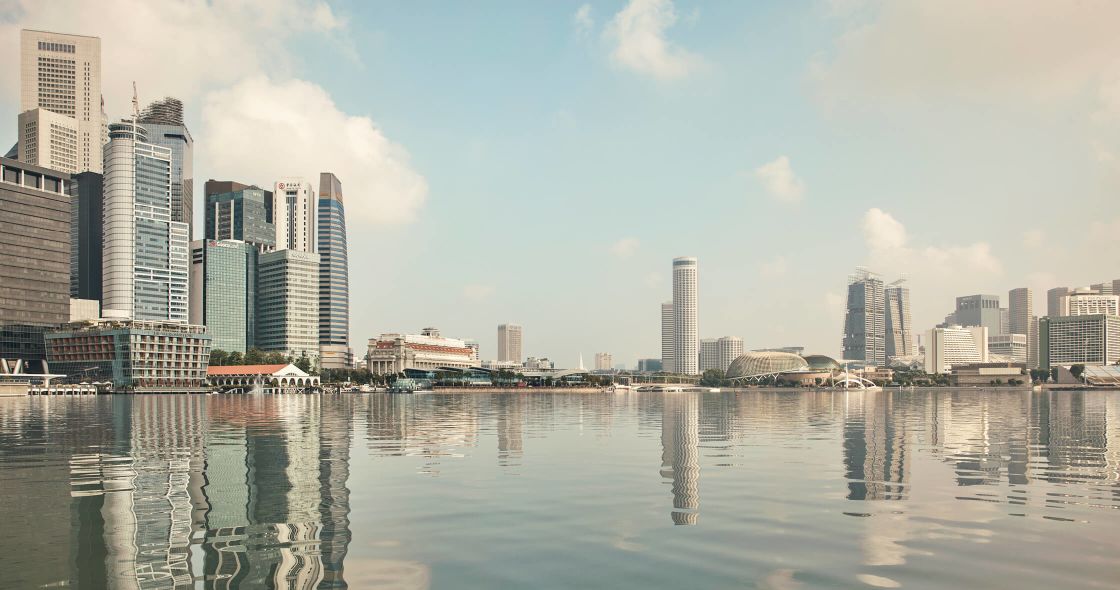 A Body Of Water With Buildings In The Background