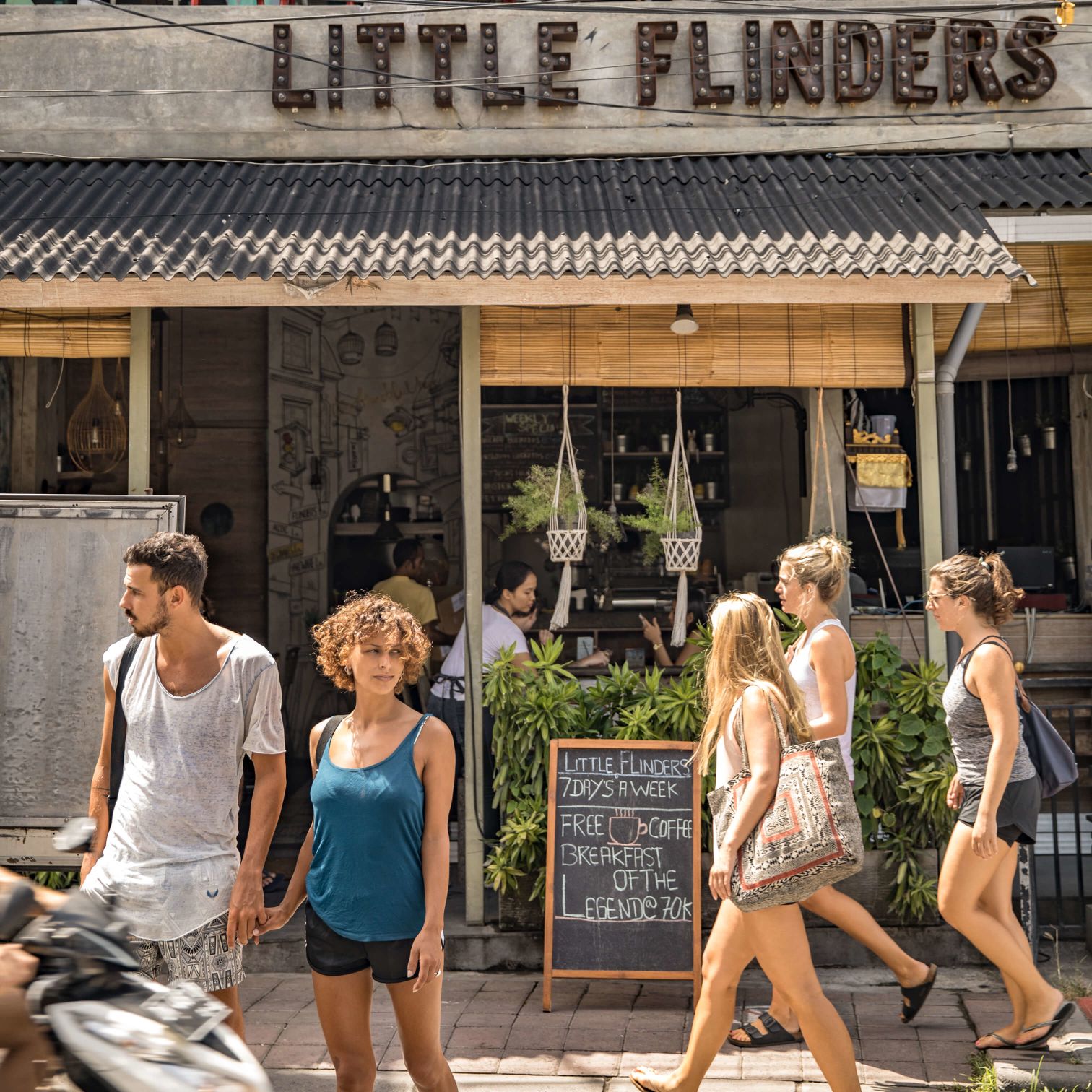 A Group Of People Walking Outside A Building