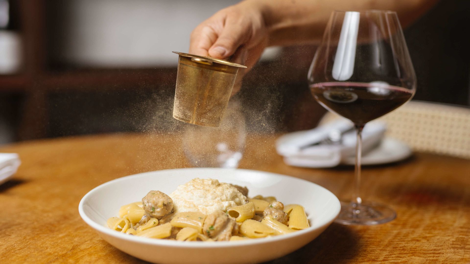 A Plate Of Food And A Glass Of Wine