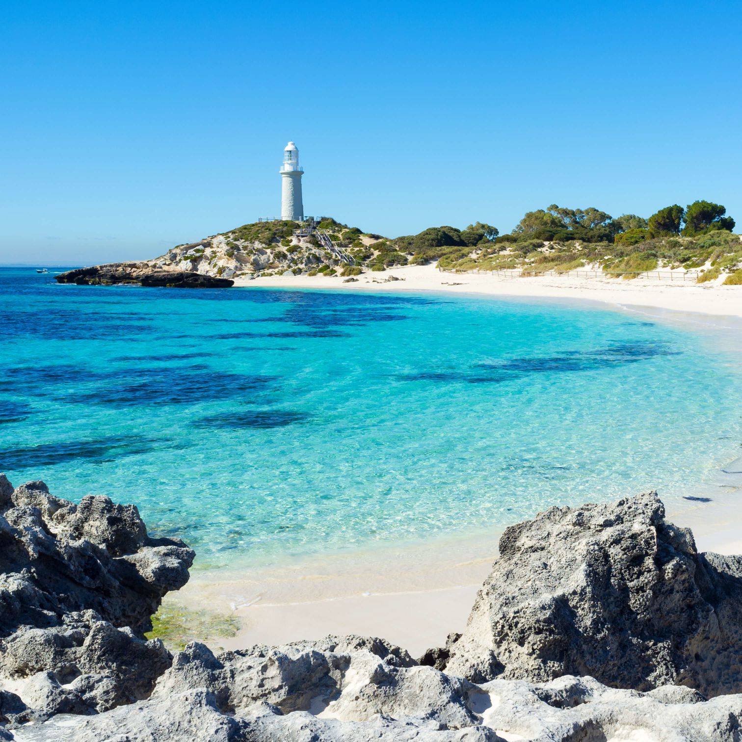 A Lighthouse On A Rocky Beach