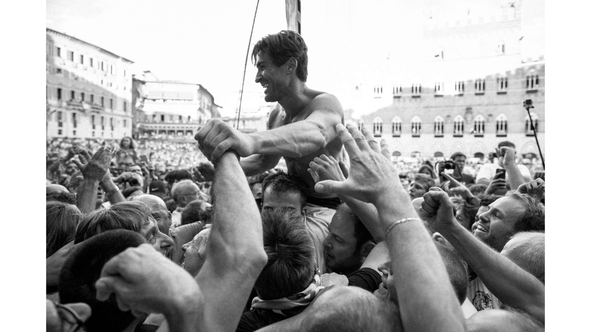A Man Sitting On A Crowd Of People
