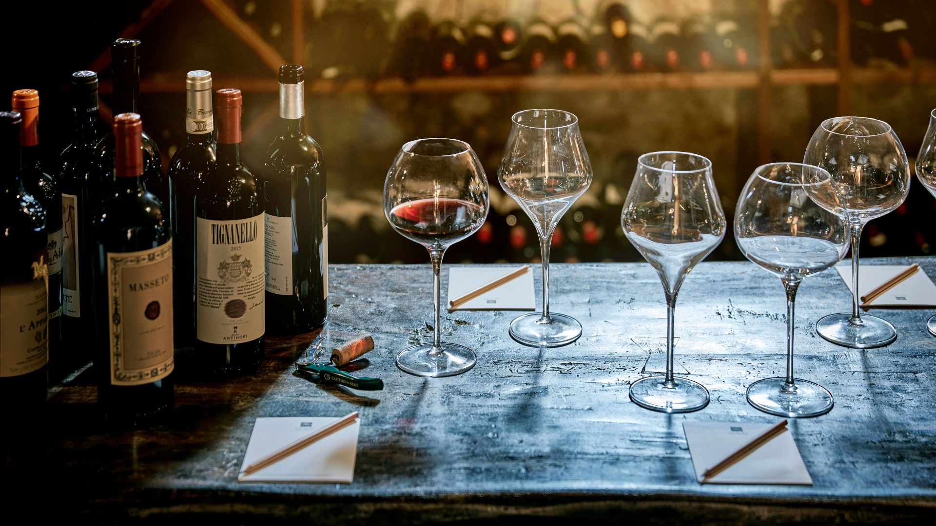 Wine Glasses And Bottles On A Table
