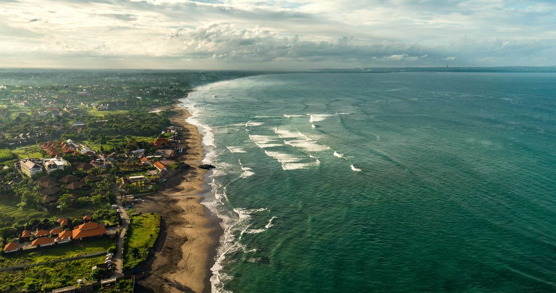 A Beach With Houses And Water