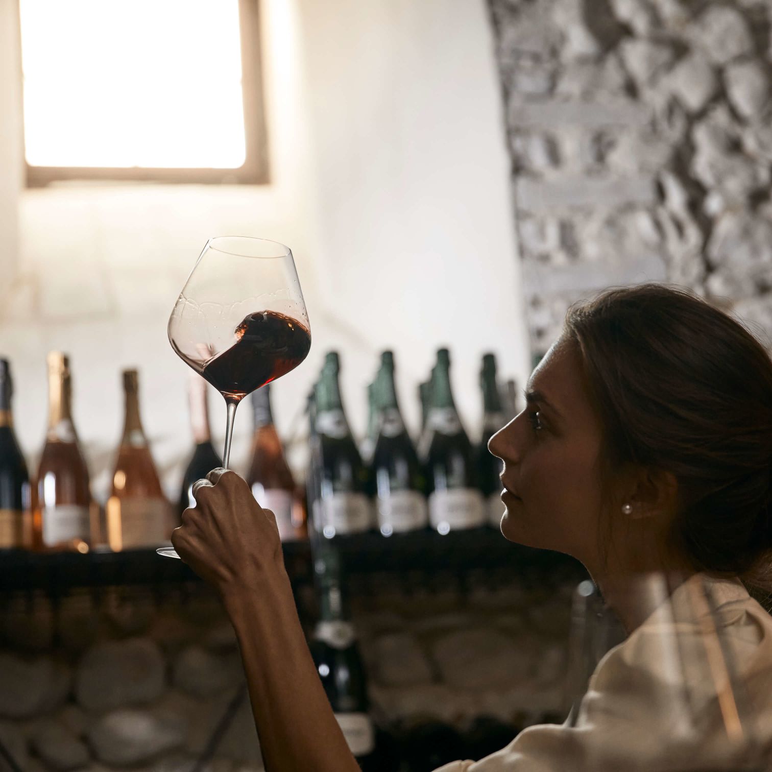 A Woman Holding A Glass Of Wine