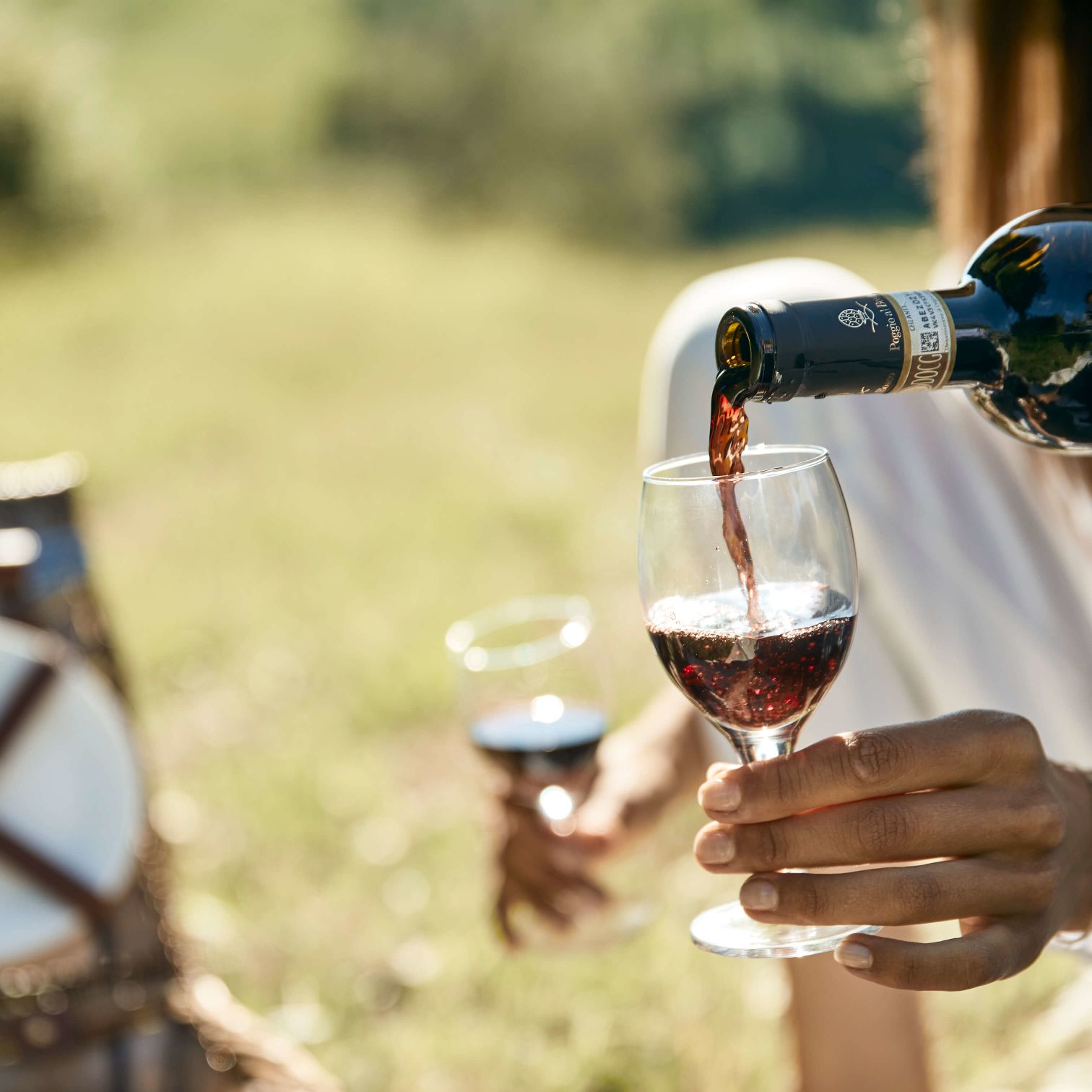 A Person Pouring Wine Into A Glass