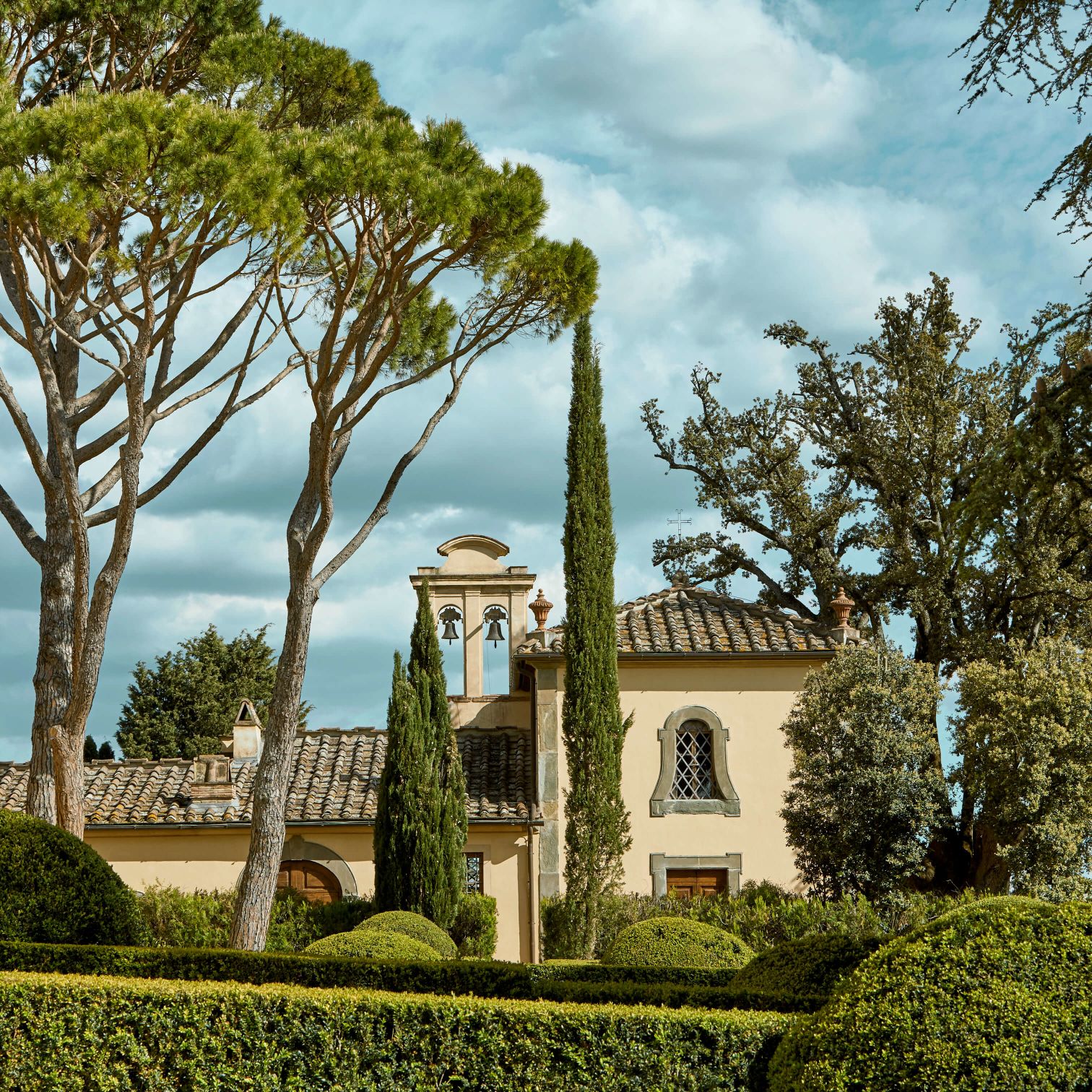 A Building With Trees And Bushes Around It