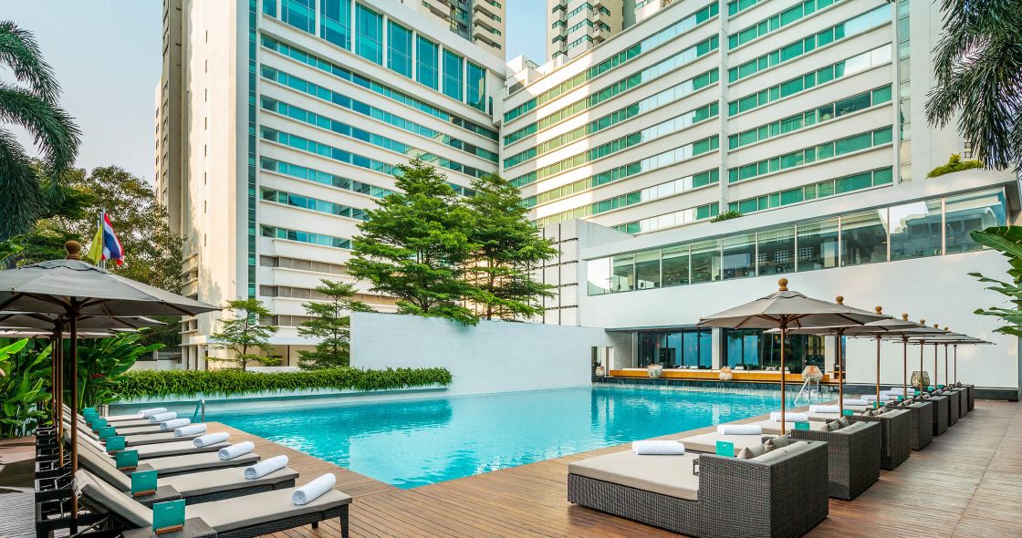 A Pool With A Building In The Background
