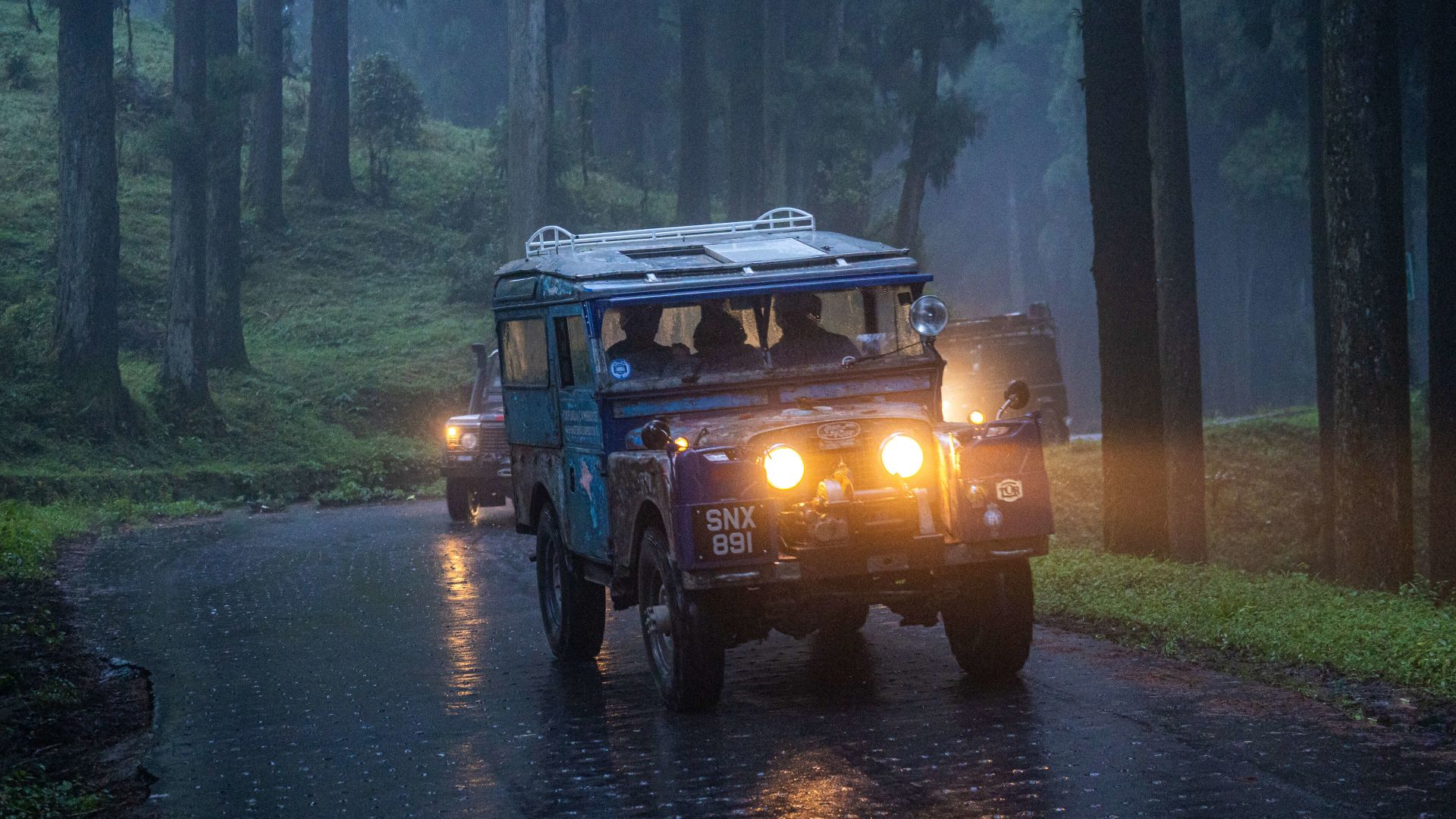 A Vehicle On A Road With Headlights On