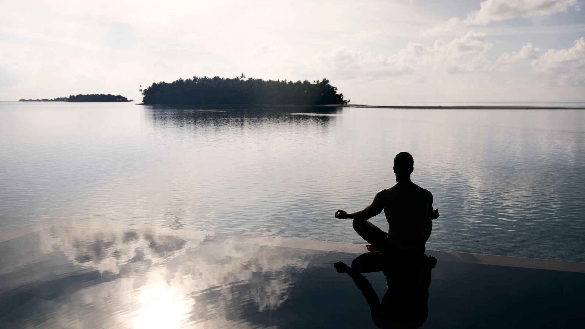 A Man Sitting On A Beach