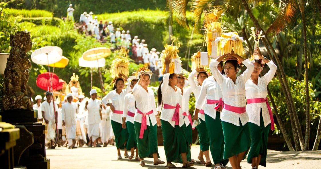 A Group Of People Wearing Hats And Holding Umbrellas