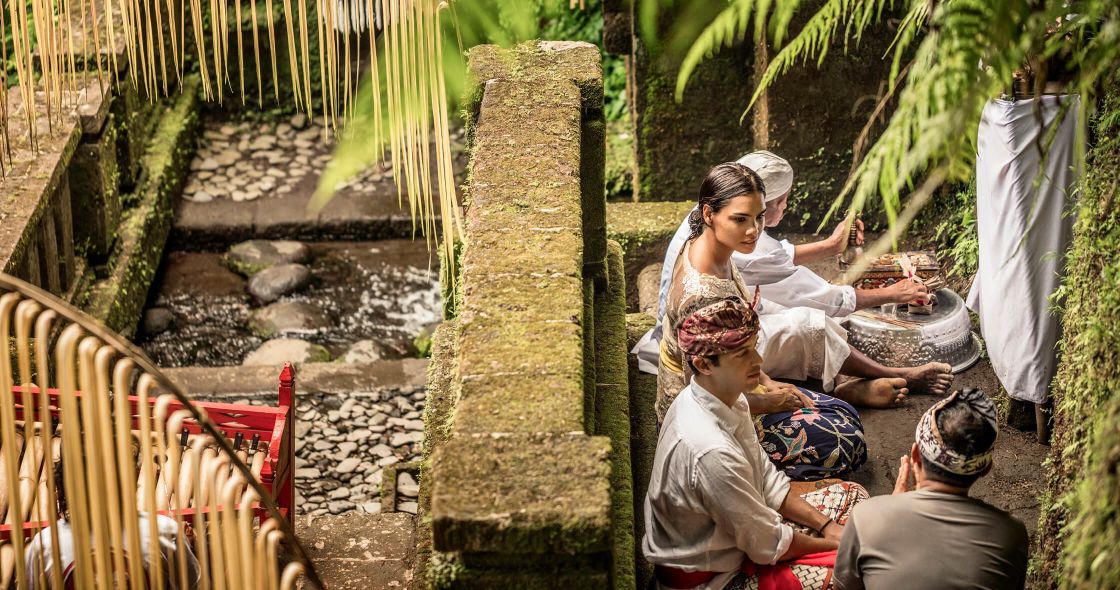 A Group Of People Sitting On A Bench