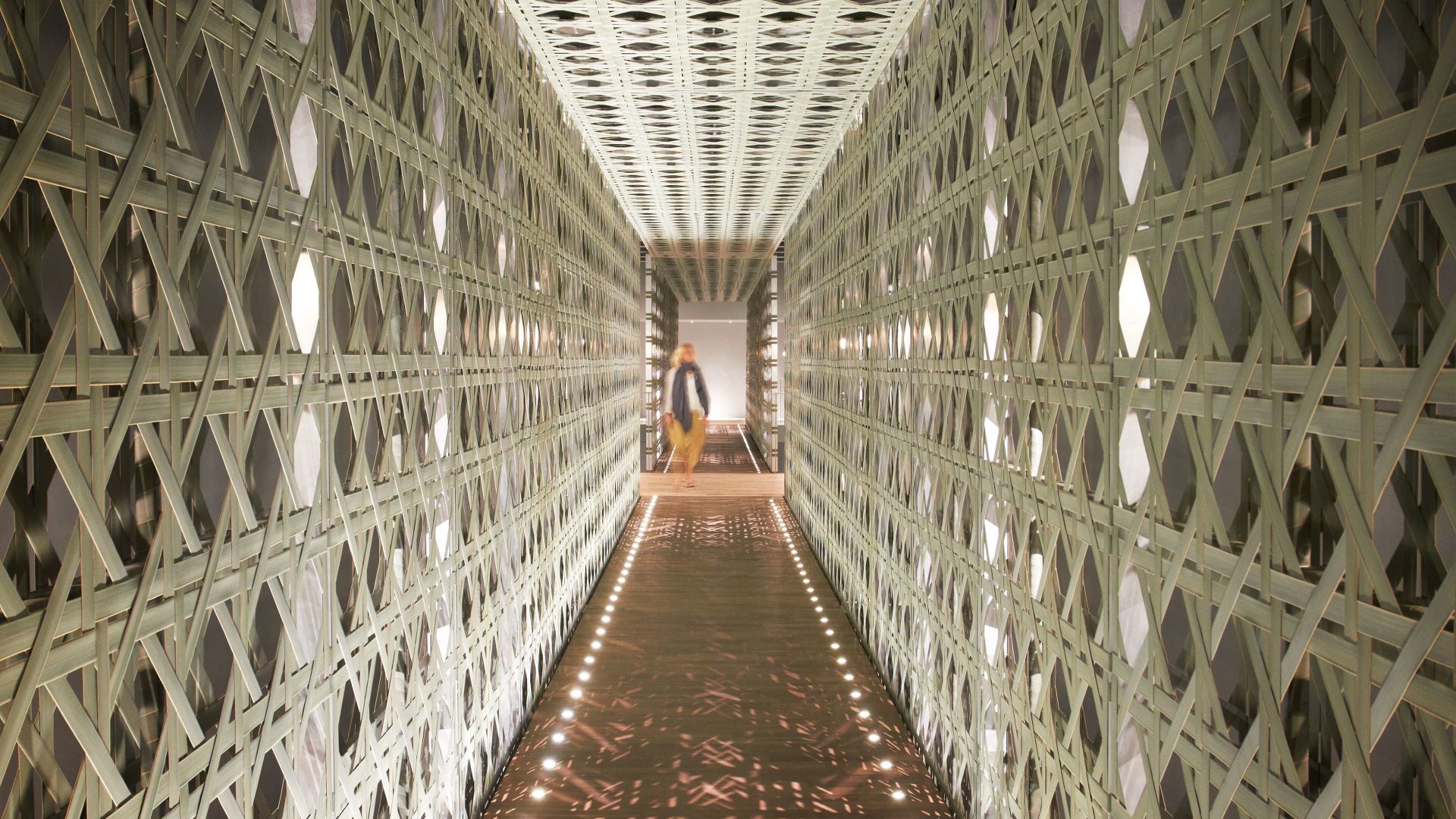 A Person Walking Down A Long Hallway