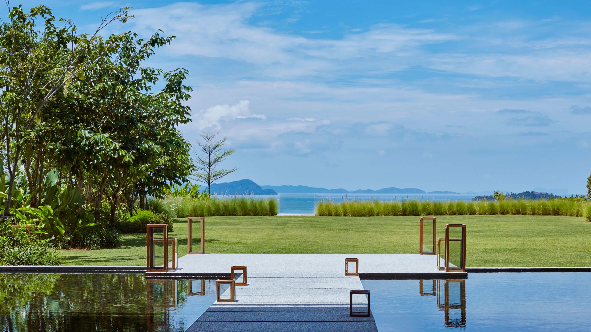 A Table And Chairs On A Deck Overlooking A Body Of Water