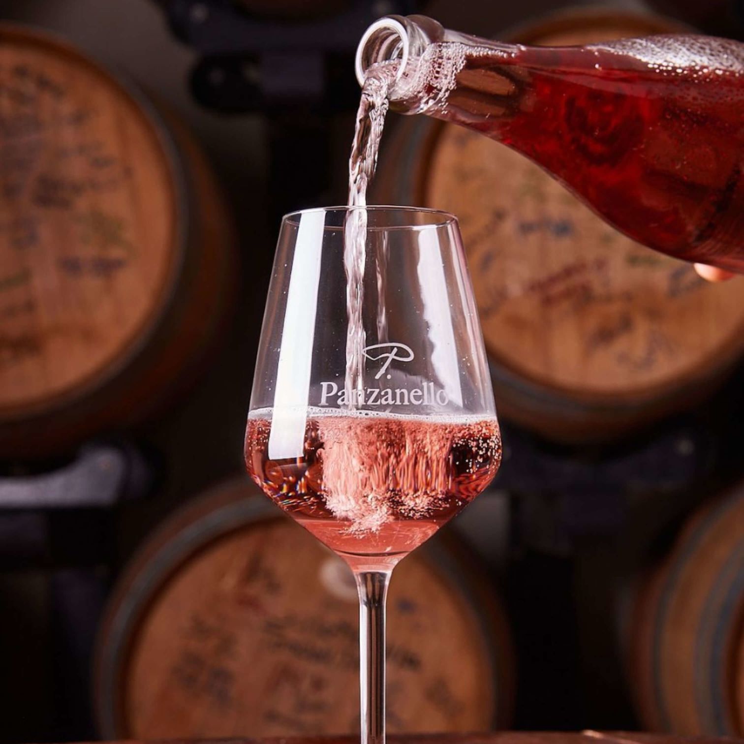A Glass Of Wine Being Poured Into A Glass