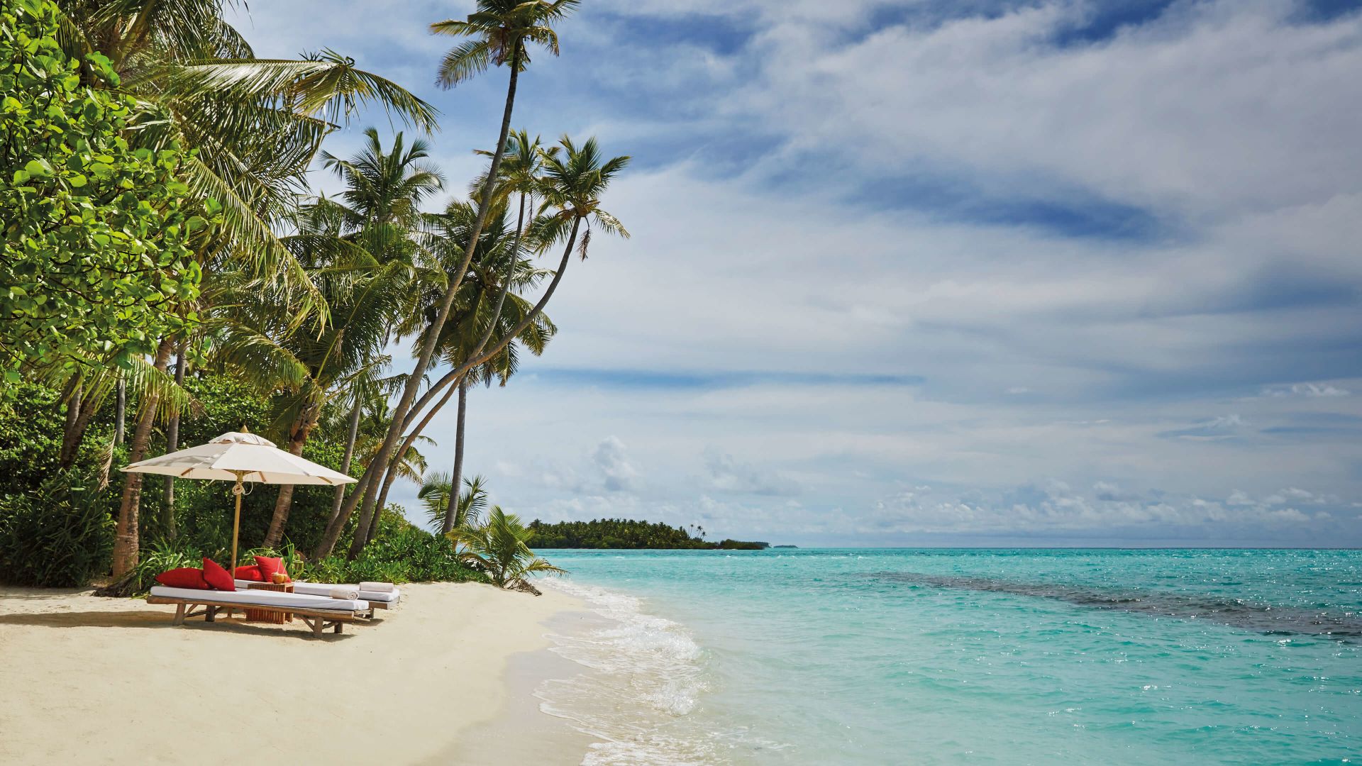 A Beach With A Chair And Umbrella