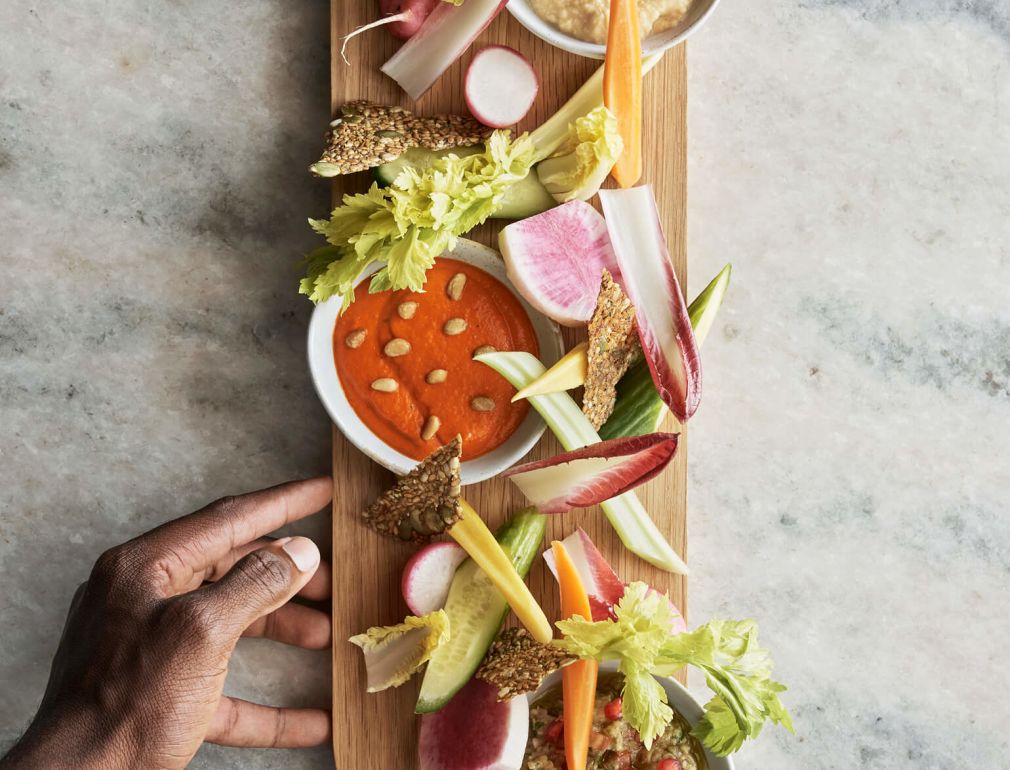 A Hand Holding A Tray Of Food