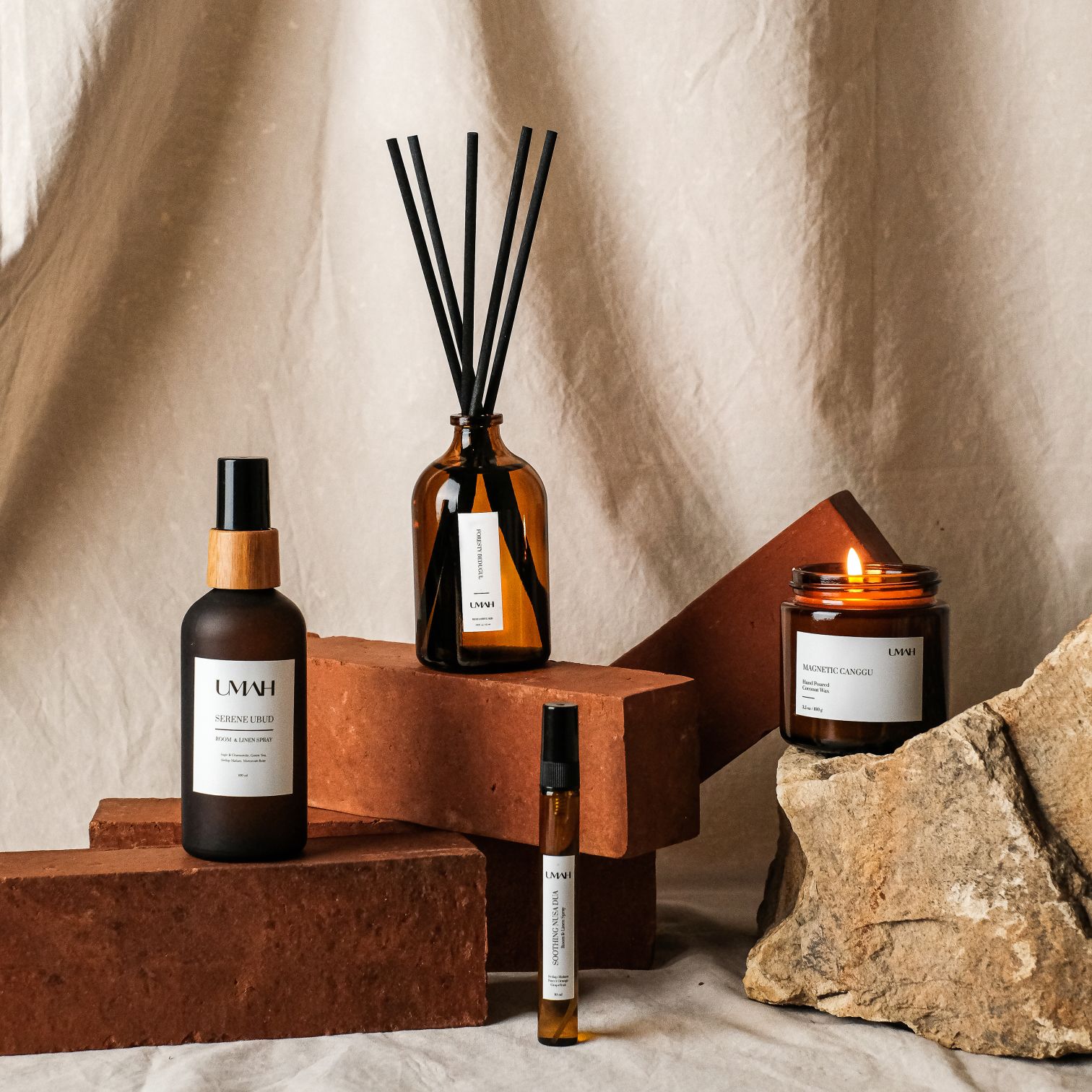 A Couple Of Bottles And A Candle On A Table