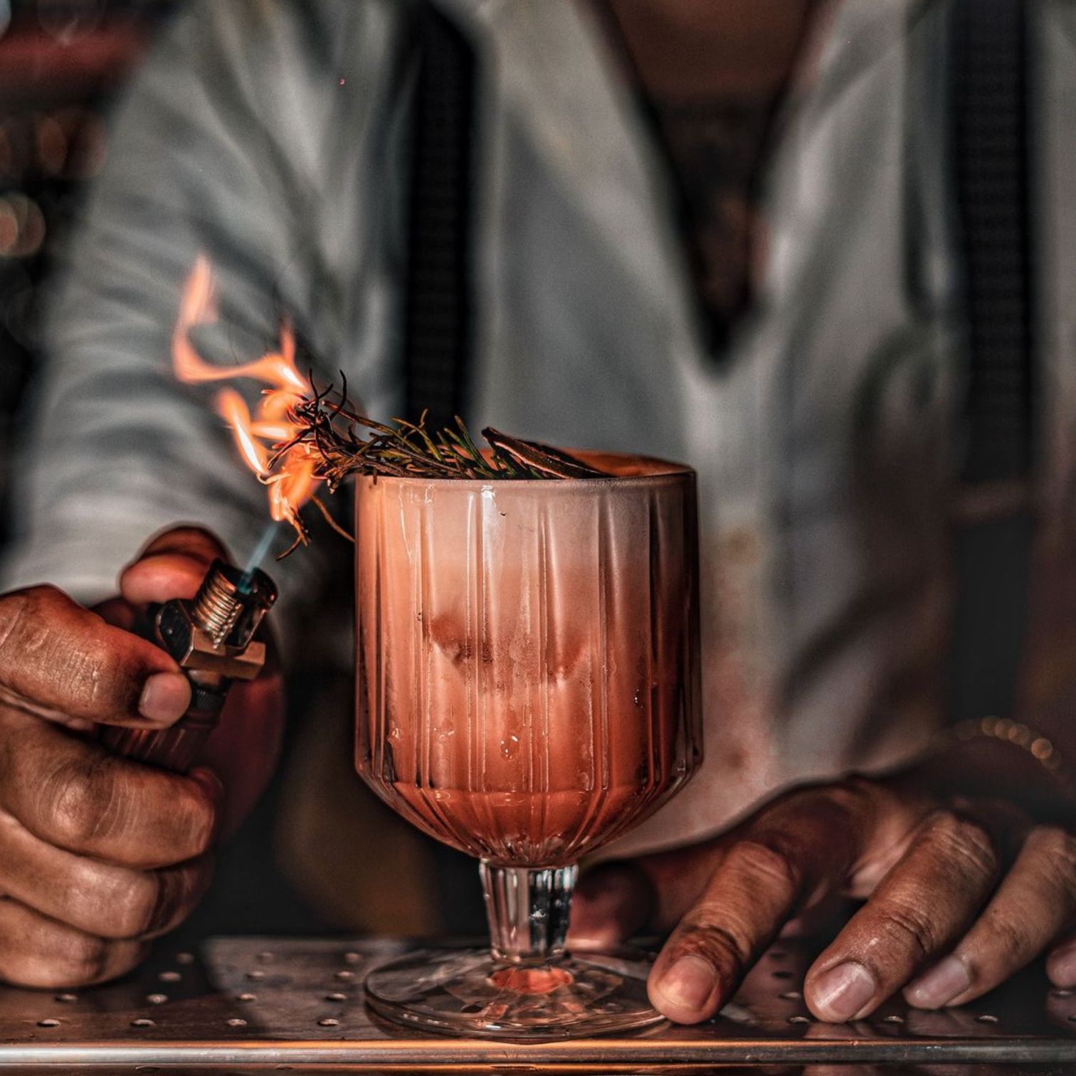A Person Pouring A Drink Into A Glass