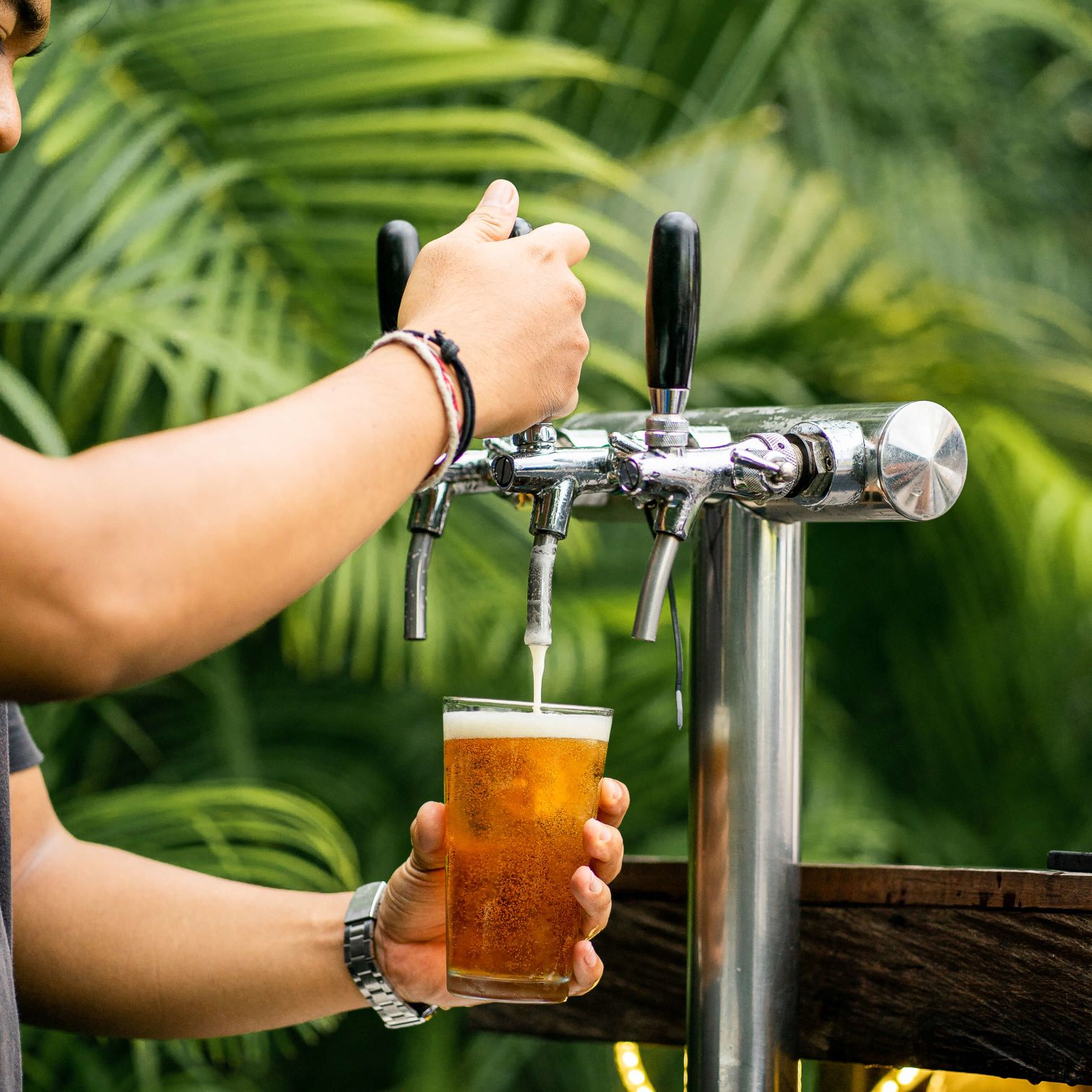 A Person Pouring A Drink Into A Glass