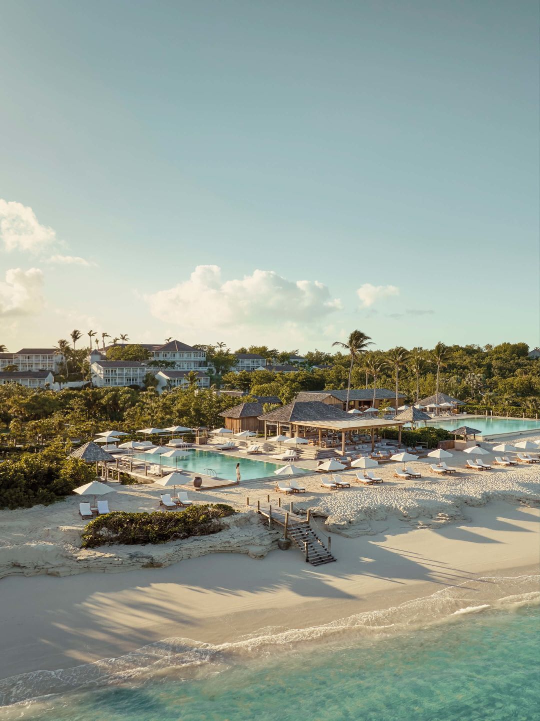 A Beach With A Pool And Buildings