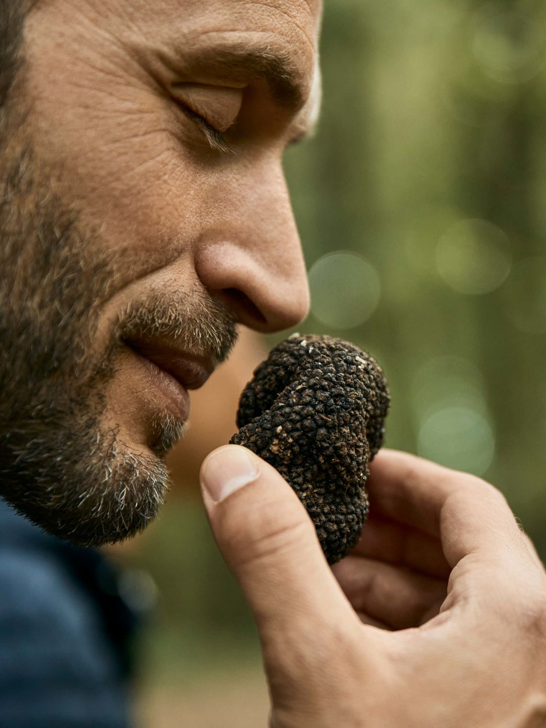A Man Eating A Small Green Object