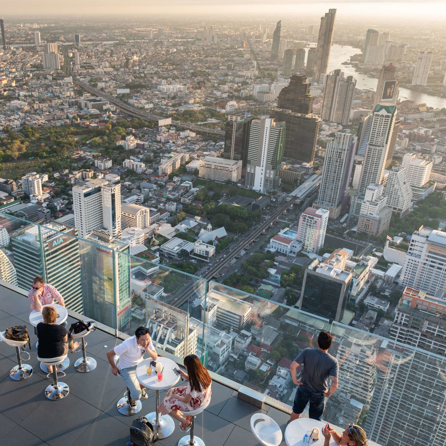 People Sitting On A Balcony Overlooking A City