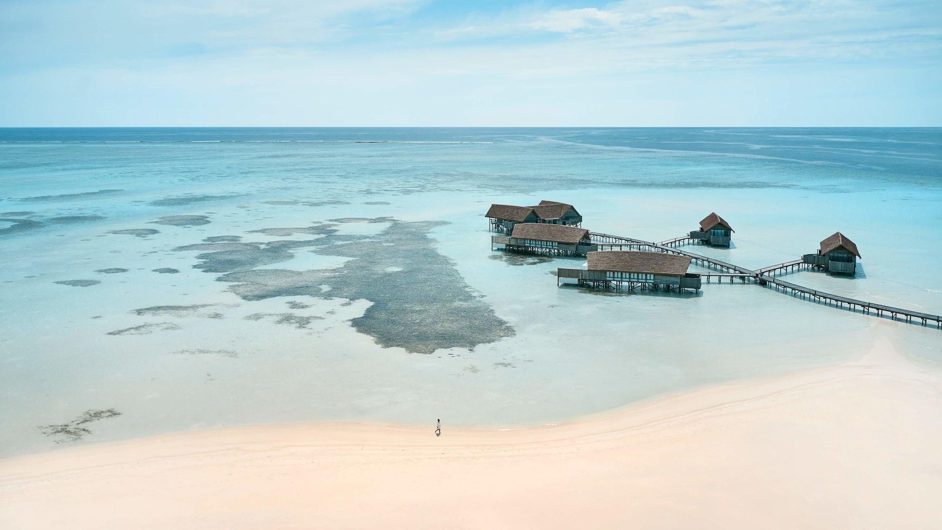 A Beach With A Pier And Buildings