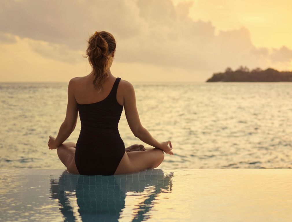 A Person Sitting On A Beach