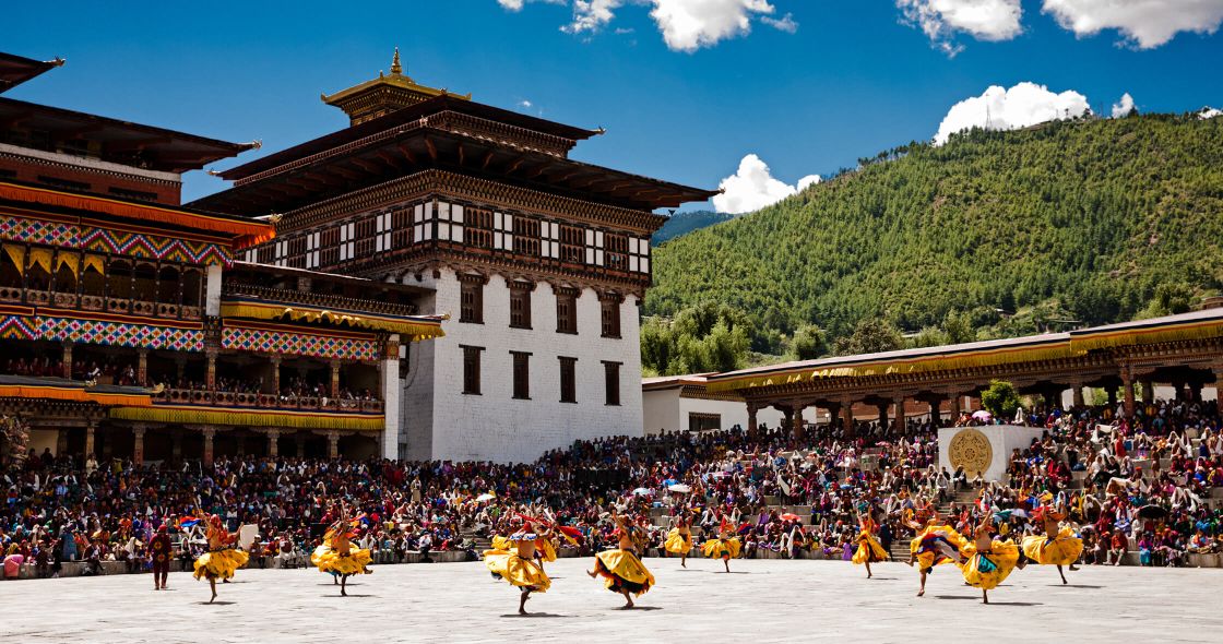 A Group Of People Performing In Front Of A Building