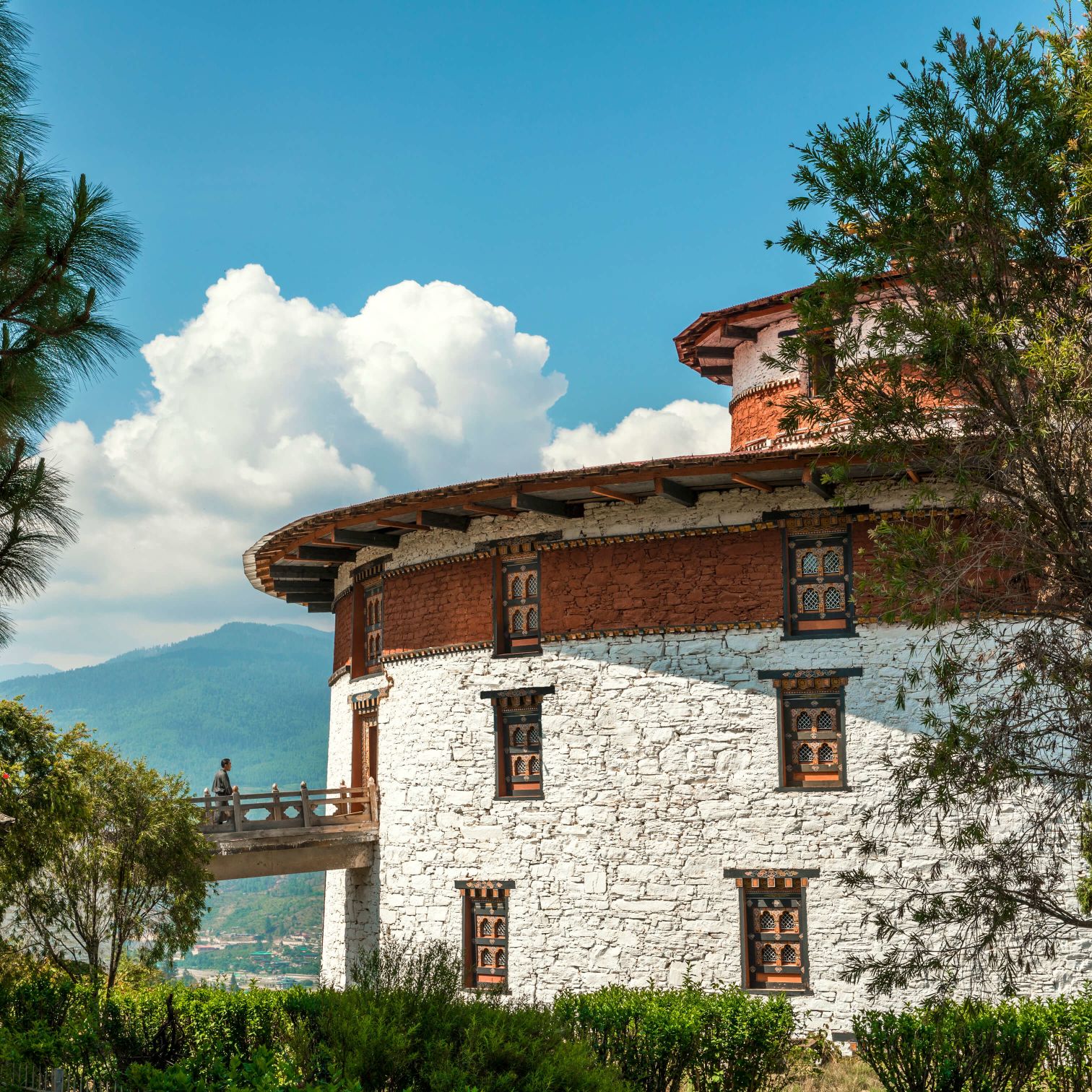 A Building With A Large Garden In Front Of It