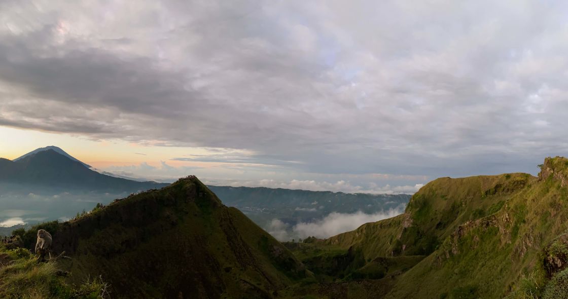 A Valley With Mountains And Clouds