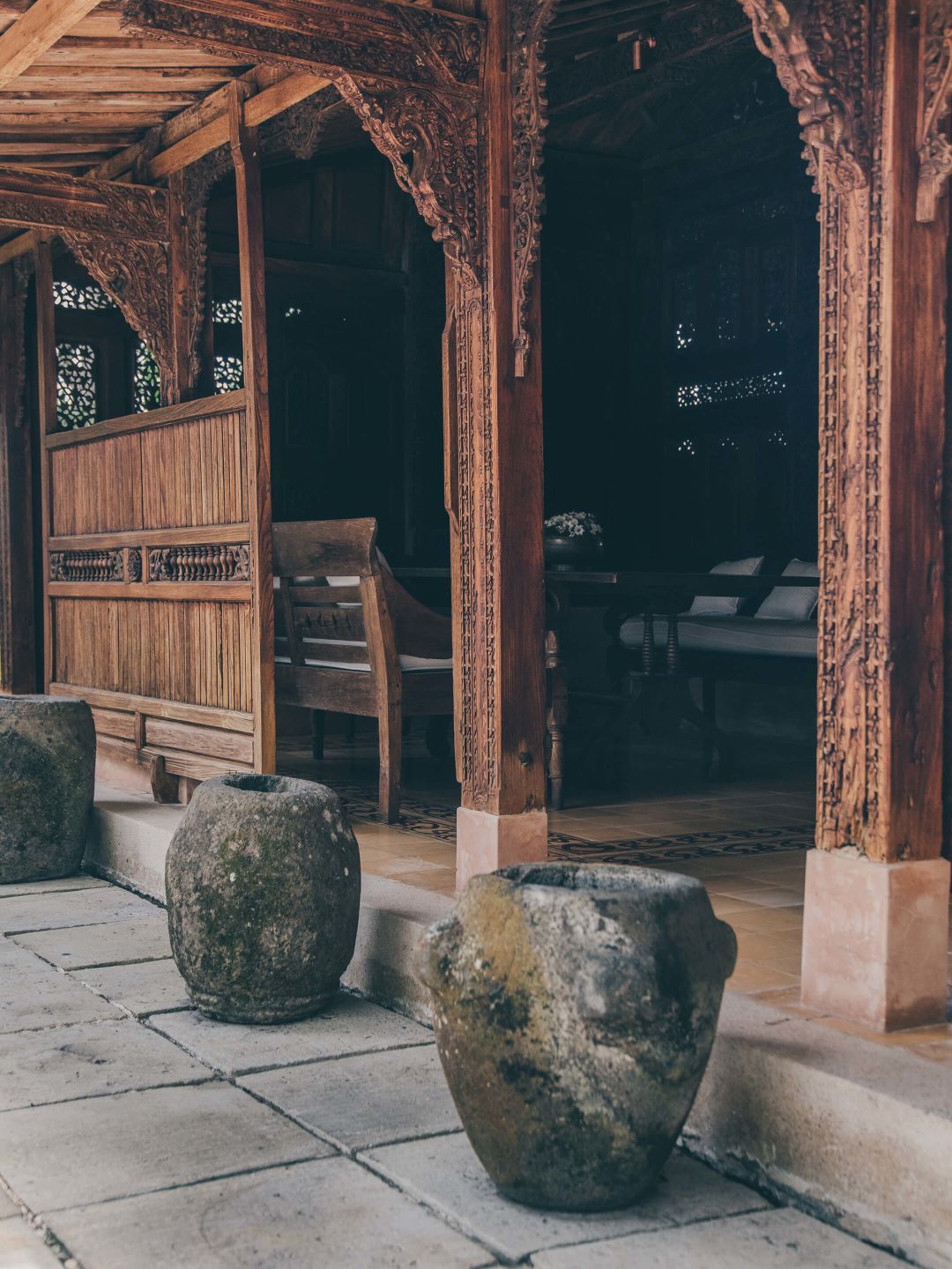 A Stone Walkway With A Large Rock In Front Of A Building