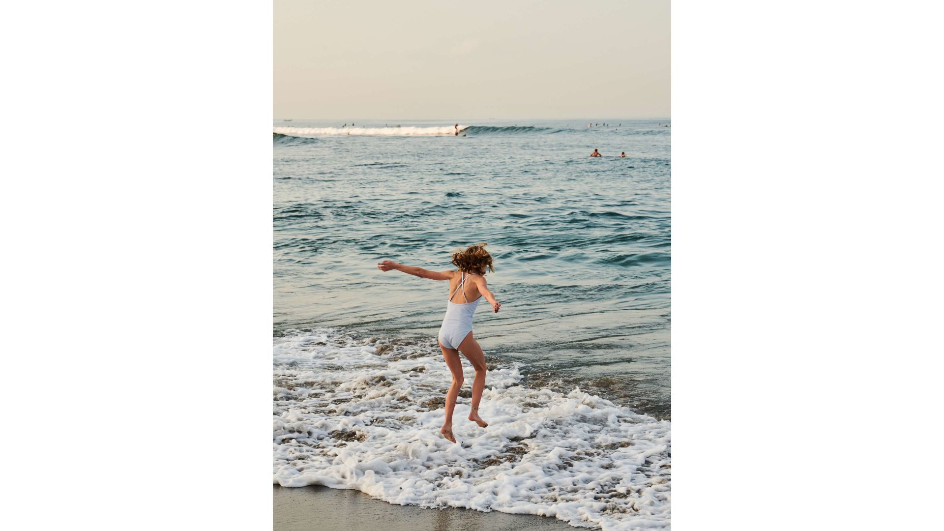 A Man In A White Dress On A Beach