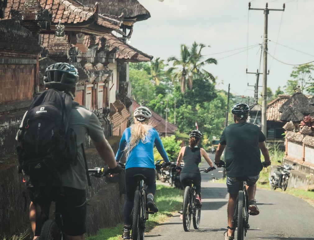 A Group Of People Riding Bikes