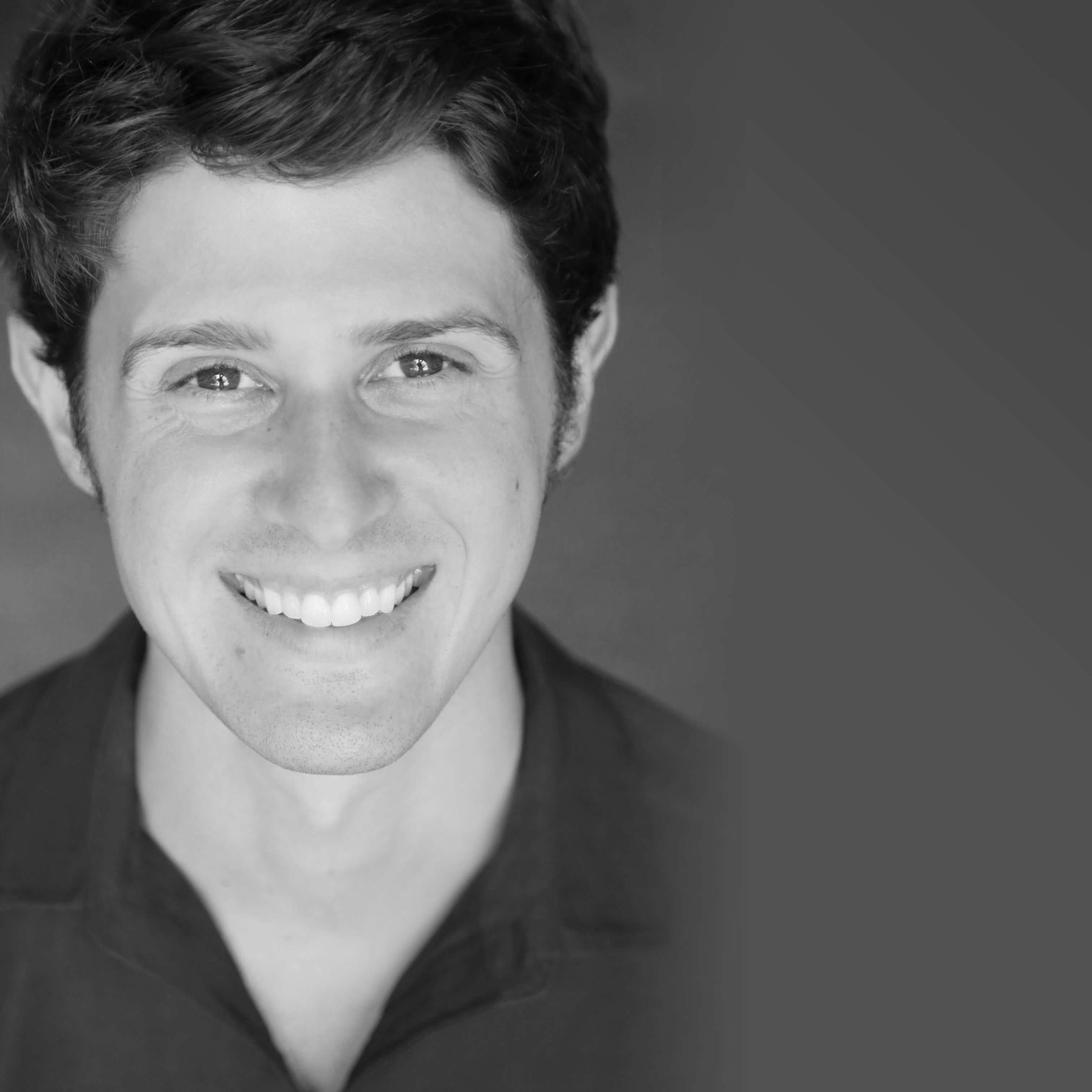A Man Smiling For The Camera