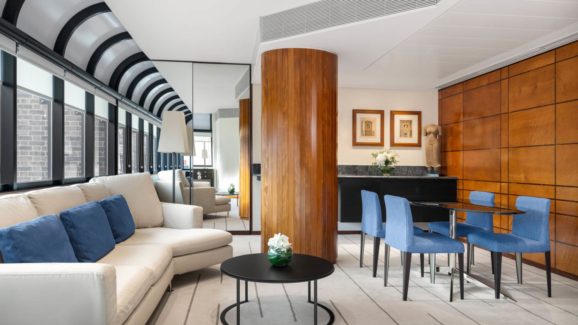 A Room With A Table Chairs And A Couch