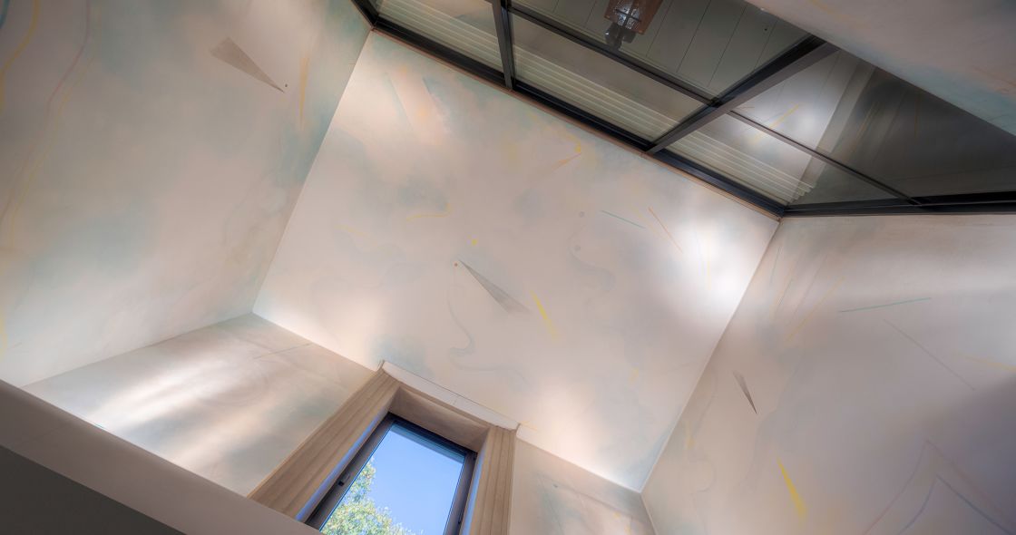 A Room With A White Ceiling And A Window