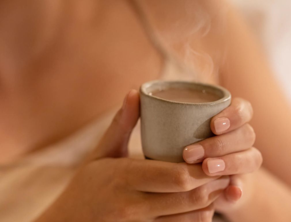 A Woman Holding A Cup