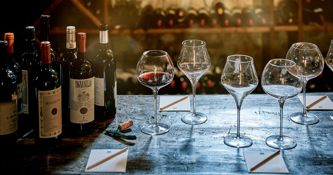 Wine Glasses And Bottles On A Table